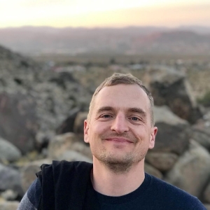 A portrait of me smiling with Joshua Tree National Park in the background